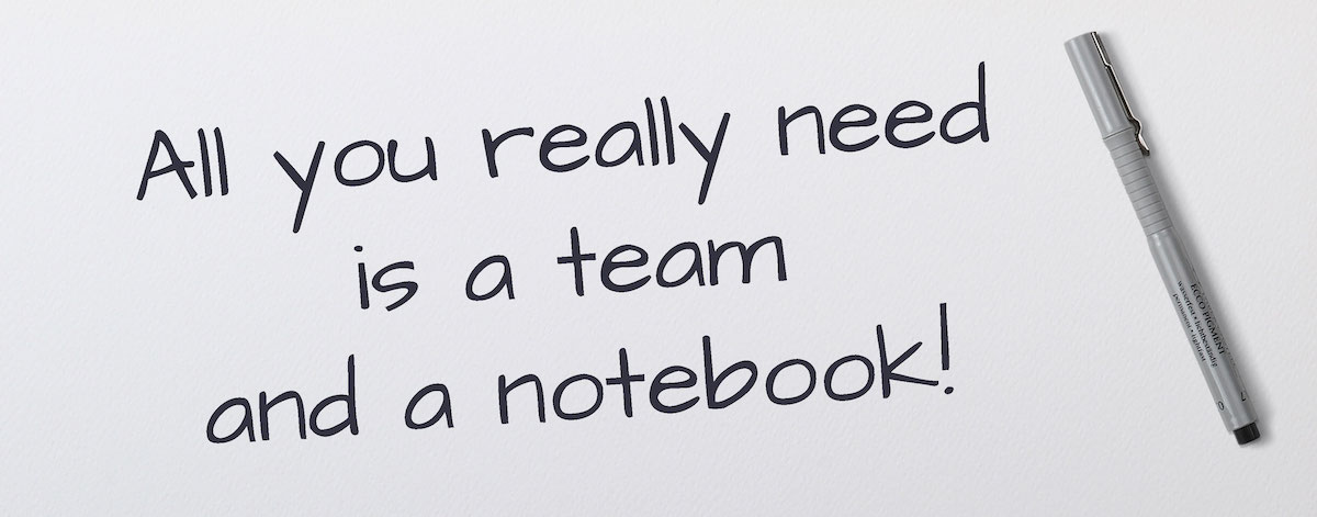 a notebook with a hand written message that says, all you really need is a team and a notebook